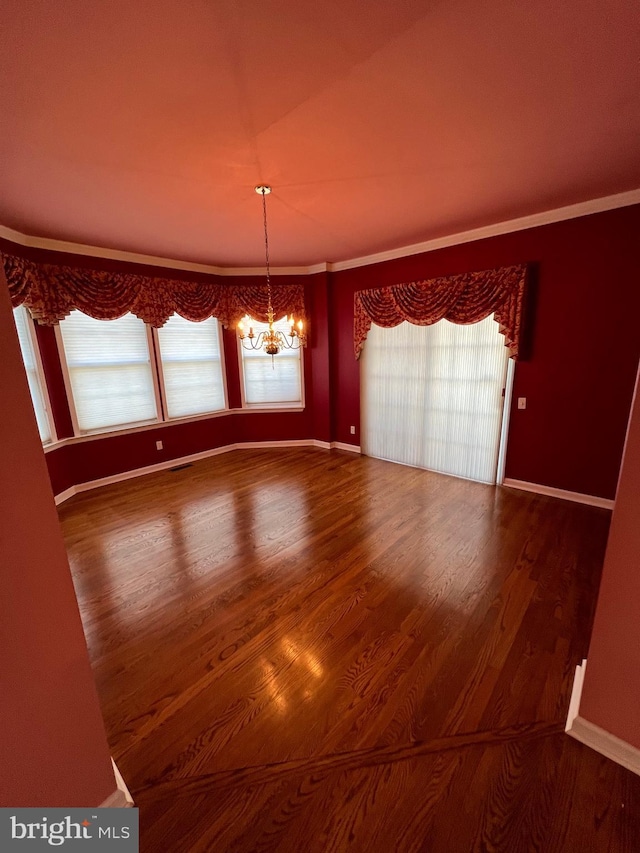 122 Lahinch Ct, Middletown, DE 19709 - unfurnished dining area featuring crown molding, baseboards, a chandelier, visible vents, and wood finished floors