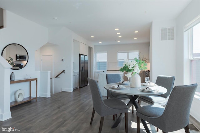 dining space with dark wood-style floors, visible vents, and recessed lighting