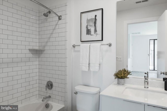 bathroom with toilet, shower / bath combination, vanity, and visible vents