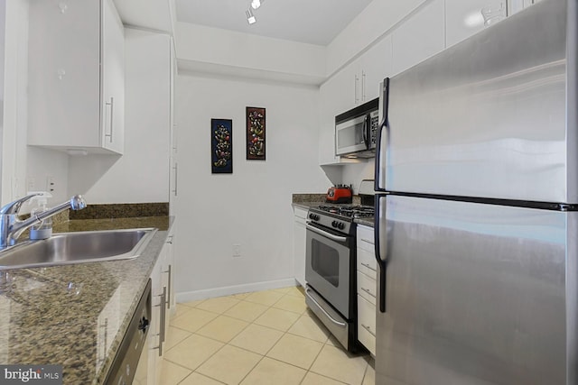 1021 N Garfield St Unit 831, Arlington, VA 22201 - kitchen featuring stainless steel appliances, dark stone counters, white cabinetry, a sink, and light tile patterned floors