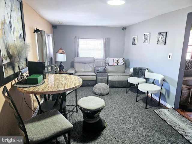 carpeted living room with baseboards