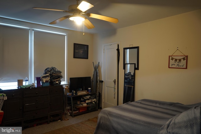 bedroom with a ceiling fan and carpet