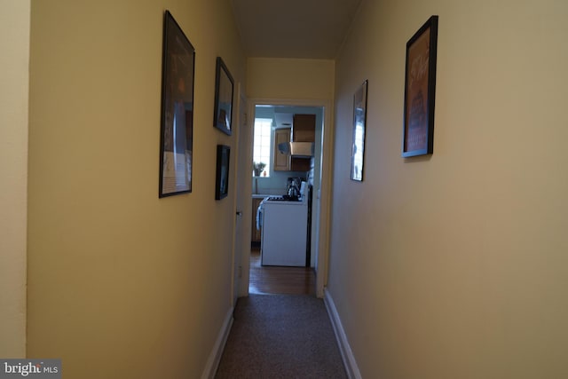 hall with baseboards and carpet