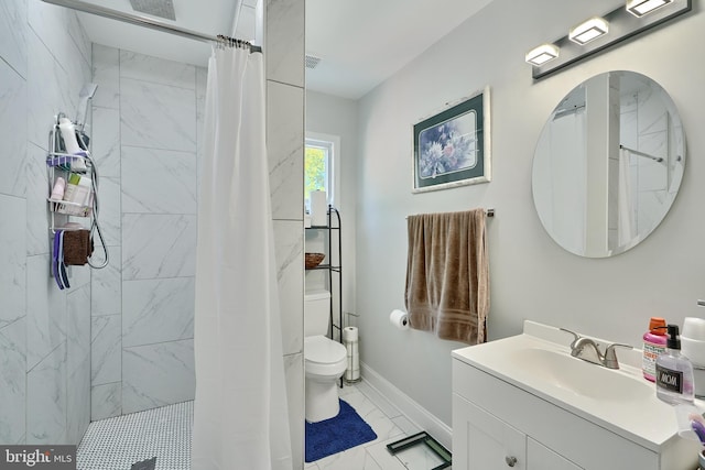 bathroom featuring vanity, baseboards, toilet, marble finish floor, and tiled shower