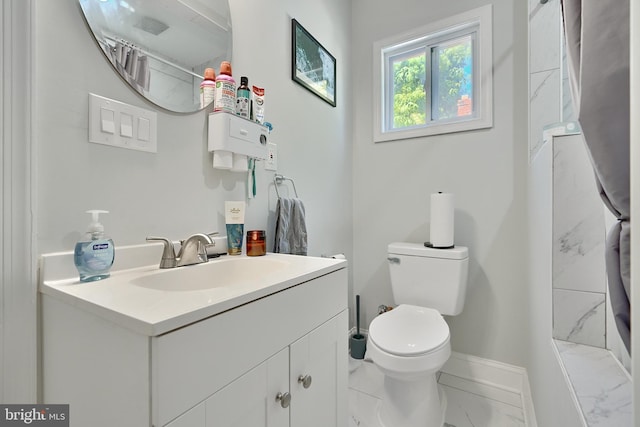 bathroom with toilet, baseboards, marble finish floor, and vanity