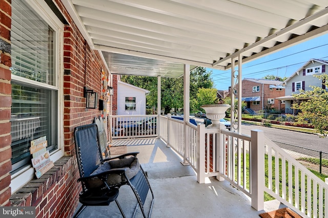 view of patio / terrace featuring a porch and a residential view