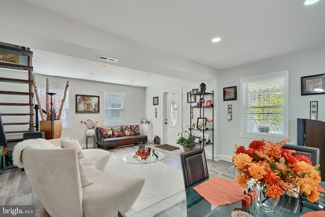 living room featuring recessed lighting, baseboards, visible vents, and light wood finished floors