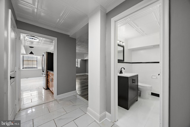 bathroom featuring baseboards, toilet, and vanity