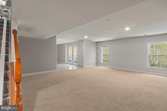 spare room with recessed lighting, baseboards, and light carpet
