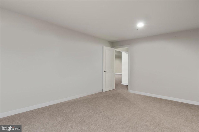unfurnished room with baseboards, light carpet, and recessed lighting
