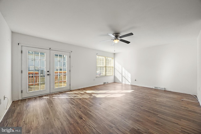 empty room featuring visible vents, french doors, a ceiling fan, and wood finished floors