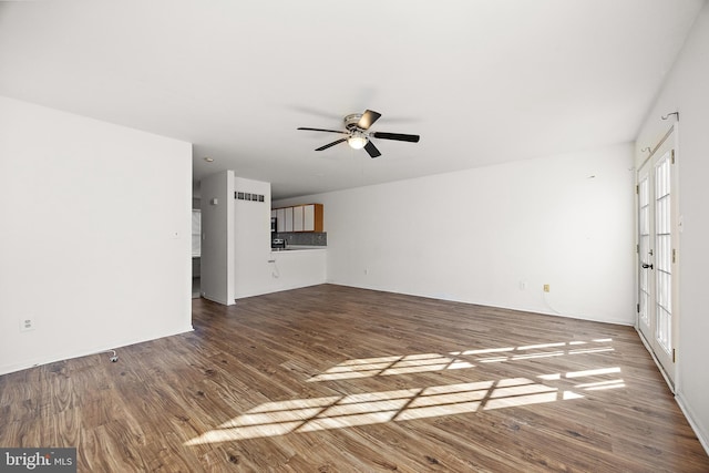 unfurnished living room featuring wood finished floors, ceiling fan, and visible vents