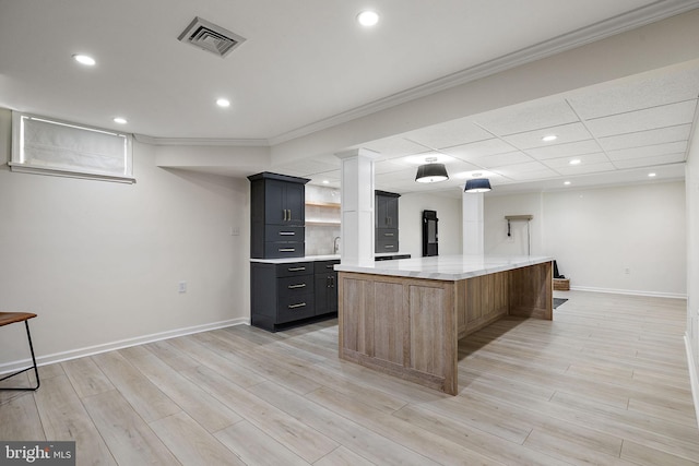kitchen with a spacious island, baseboards, visible vents, and open shelves