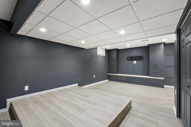 interior space featuring baseboards, light wood finished floors, and recessed lighting