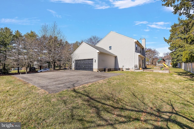 view of property exterior with a garage, central AC unit, a chimney, a playground, and driveway