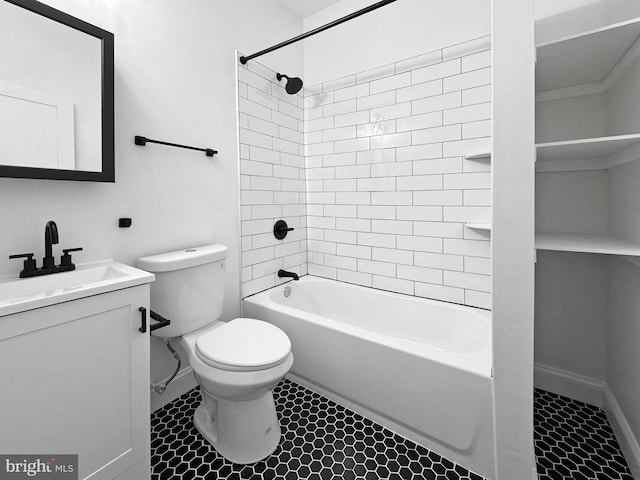 bathroom with toilet, vanity, bathing tub / shower combination, and baseboards