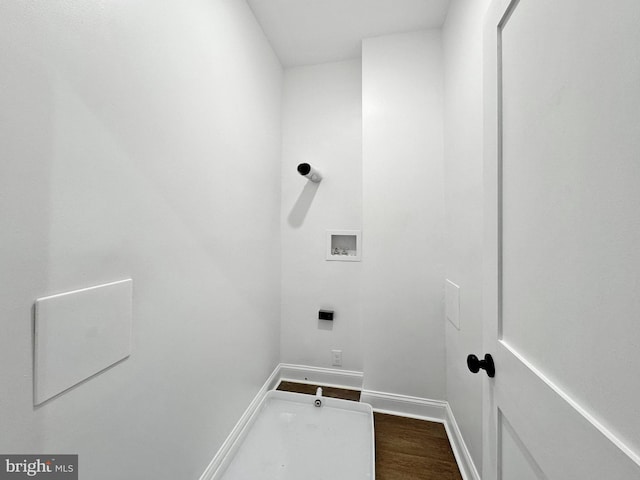 clothes washing area featuring dark wood-type flooring, laundry area, baseboards, and hookup for a washing machine