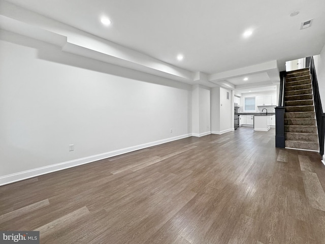 unfurnished living room featuring baseboards, recessed lighting, stairway, dark wood-type flooring, and visible vents