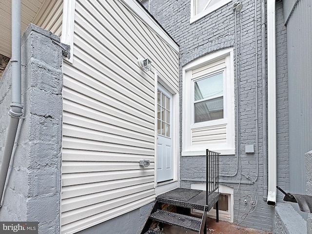 entrance to property featuring brick siding