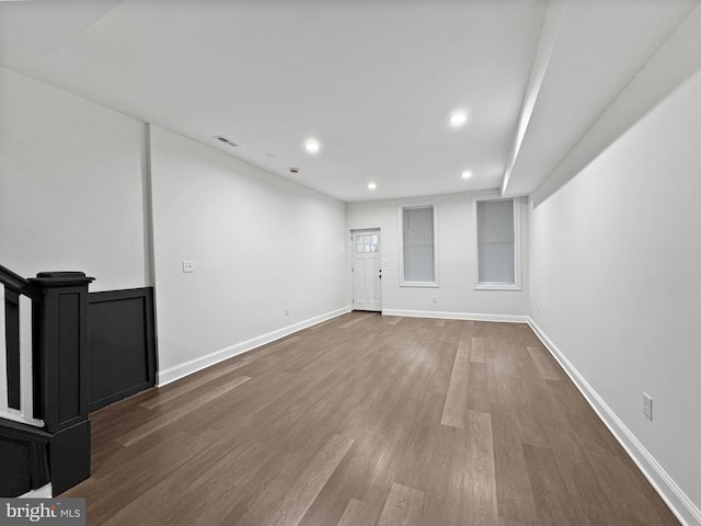 basement with dark wood-style flooring, baseboards, visible vents, and recessed lighting