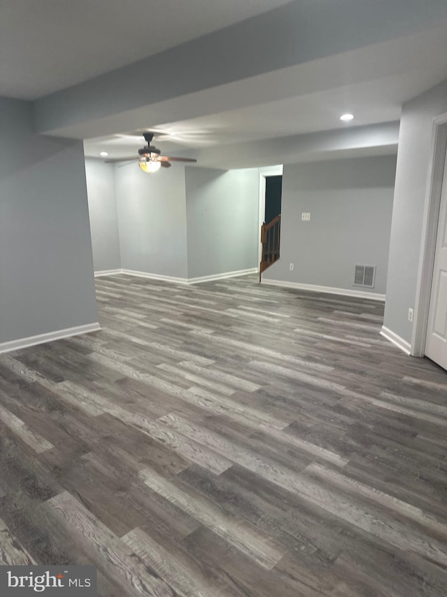 finished basement featuring recessed lighting, baseboards, a ceiling fan, dark wood-type flooring, and visible vents
