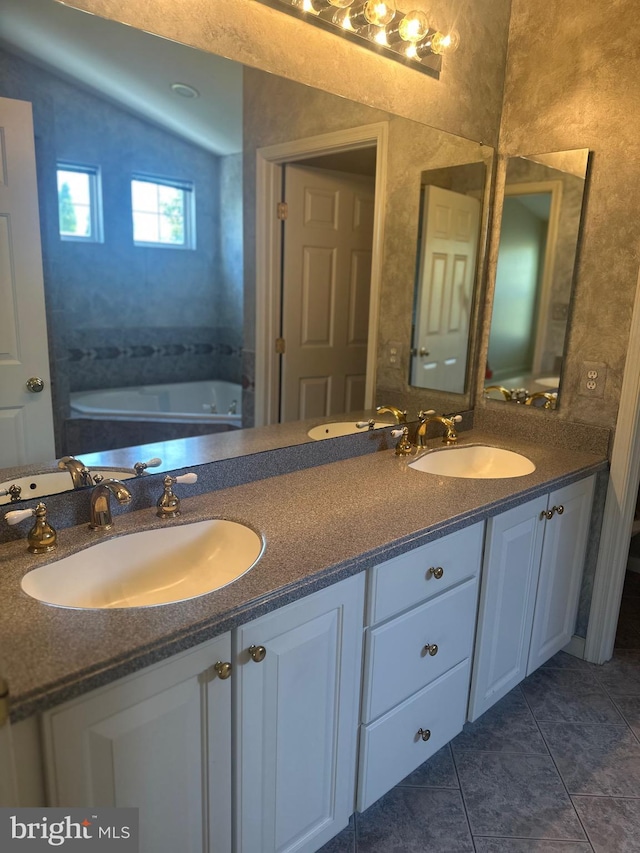 full bath featuring double vanity, a sink, and tile patterned flooring