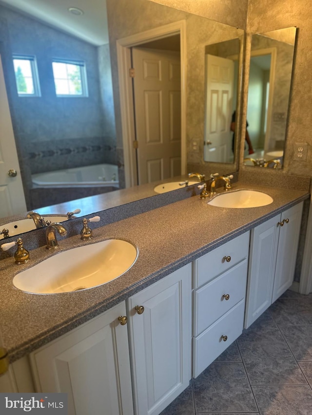 full bathroom with a sink, tile patterned floors, and double vanity
