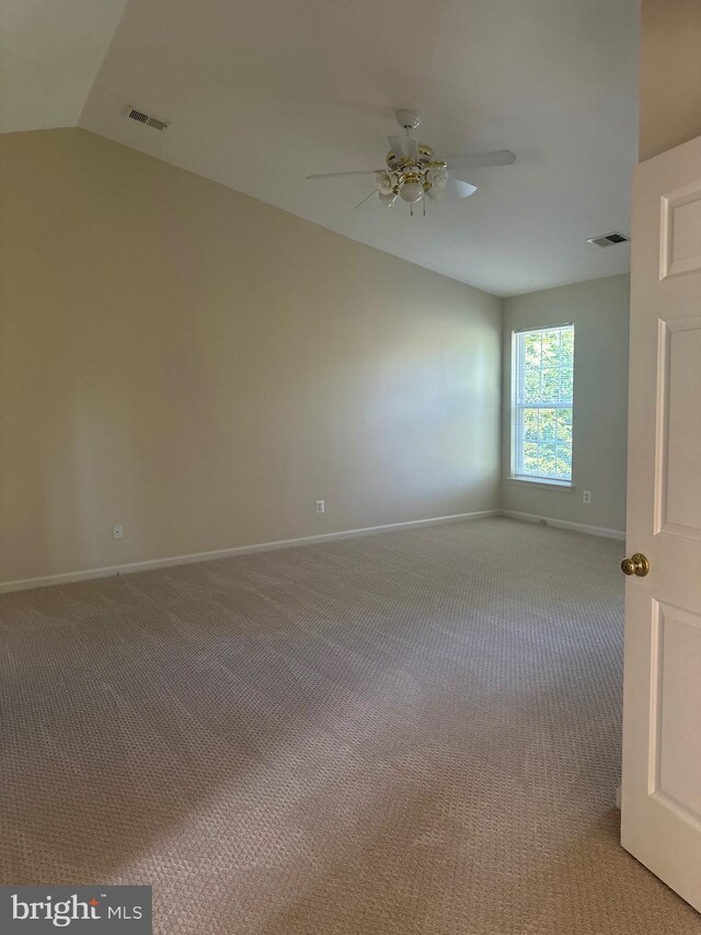 empty room featuring baseboards, ceiling fan, light carpet, and visible vents