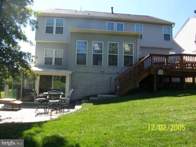 rear view of house featuring stairs, a yard, a patio area, and a deck