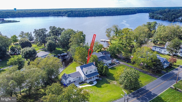 aerial view with a water view and a forest view