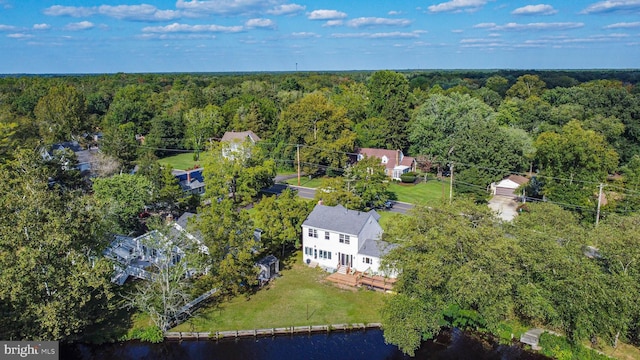drone / aerial view featuring a water view and a wooded view