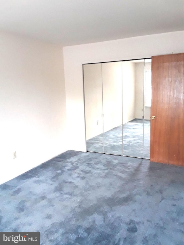 unfurnished bedroom with a closet