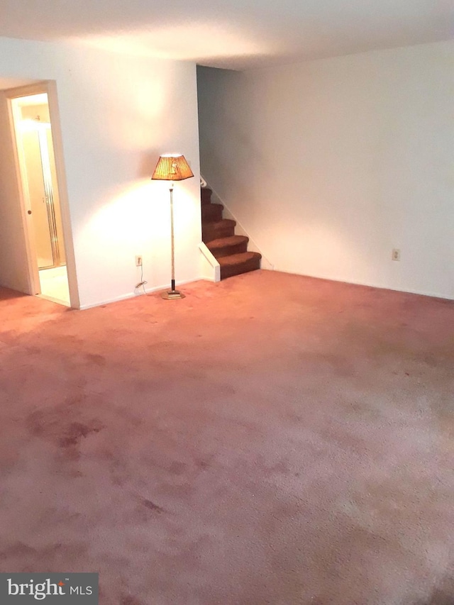 basement featuring carpet flooring and stairway