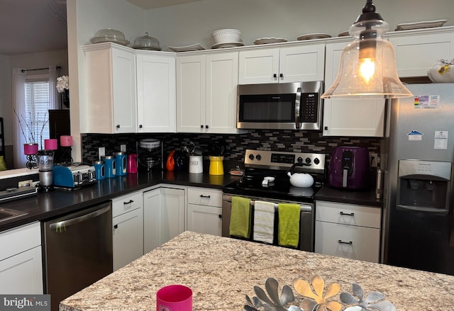 610 Beechwood Ave, Milford, DE 19963 - kitchen with decorative backsplash, pendant lighting, white cabinets, and appliances with stainless steel finishes