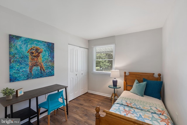 bedroom featuring baseboards, a closet, and wood finished floors