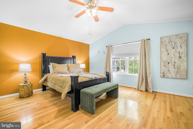 bedroom featuring vaulted ceiling, baseboards, a ceiling fan, and wood-type flooring