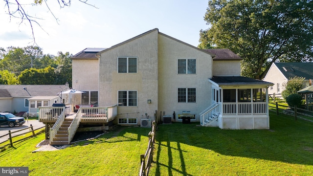 rear view of property with central AC, fence, stairs, a deck, and a sunroom