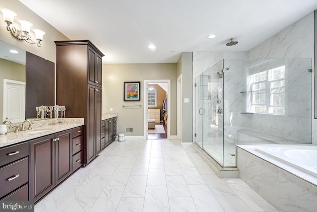bathroom with a shower stall, marble finish floor, recessed lighting, vanity, and a garden tub