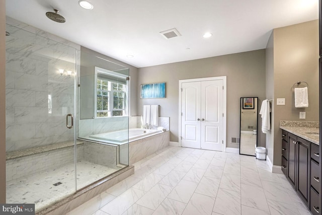full bathroom featuring a bath, a shower stall, marble finish floor, recessed lighting, and vanity
