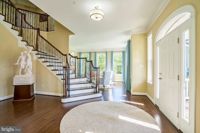 foyer with dark wood-style floors, baseboards, and stairway
