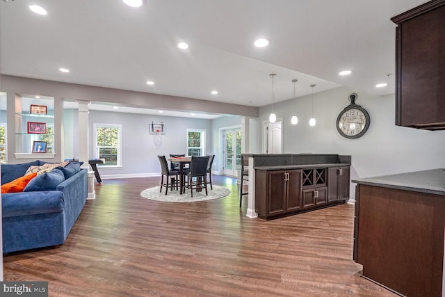 kitchen with recessed lighting, baseboards, dark countertops, dark wood-style floors, and dark brown cabinetry