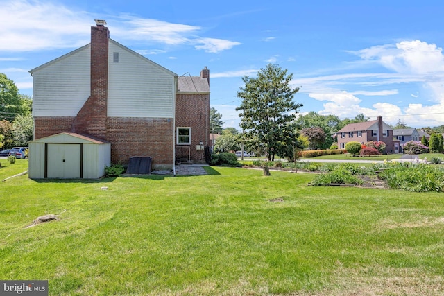view of grassy yard featuring a storage unit and an outdoor structure