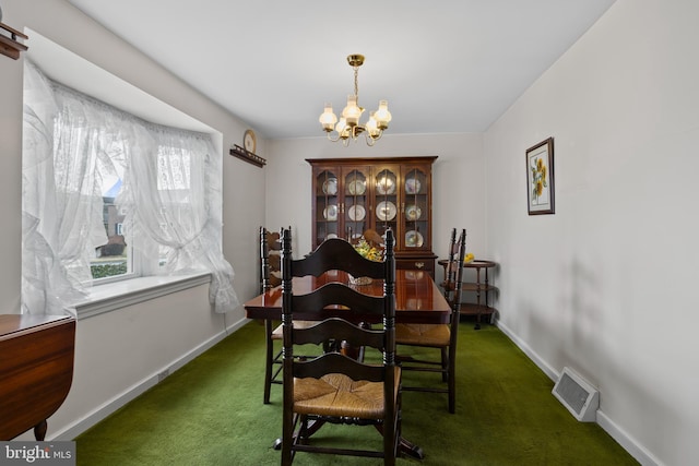 carpeted dining space featuring a chandelier and baseboards