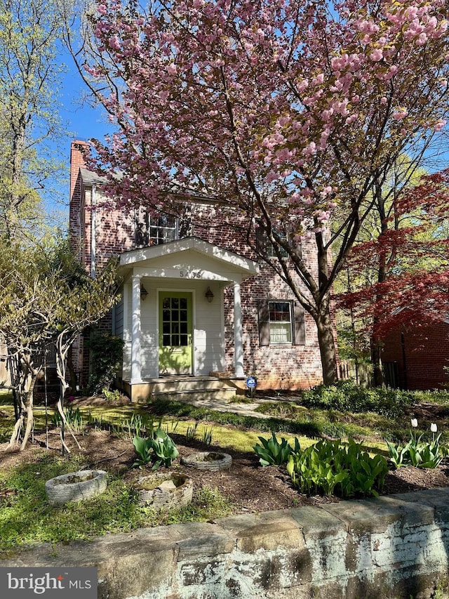 obstructed view of property featuring brick siding