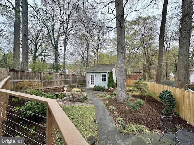 view of yard with a fenced backyard and an outdoor structure