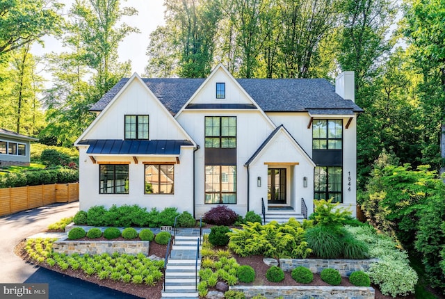 1544 Forest Villa Ln, Mclean, VA 22101 - view of front of property featuring a chimney, a standing seam roof, a shingled roof, and metal roof