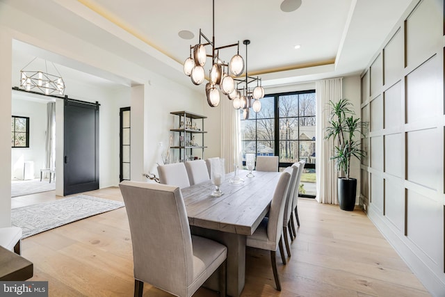 1544 Forest Villa Ln, Mclean, VA 22101 - dining room with a raised ceiling, a barn door, a chandelier, and light wood-style flooring