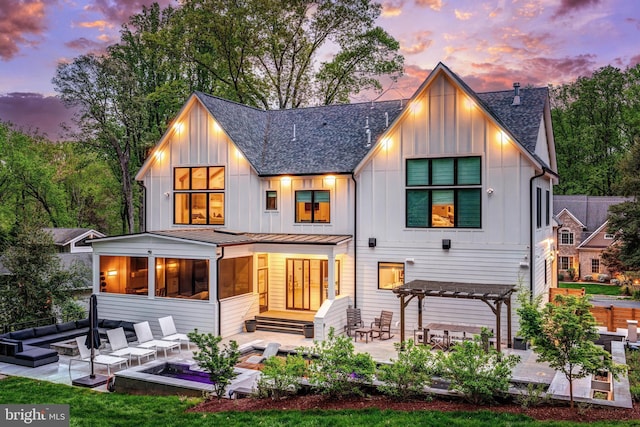 1544 Forest Villa Ln, Mclean, VA 22101 - rear view of house with board and batten siding, an outdoor living space with a fire pit, a shingled roof, and a patio area