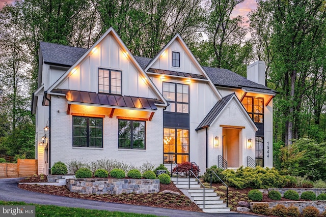 1544 Forest Villa Ln, Mclean, VA 22101 - modern farmhouse style home featuring a standing seam roof, brick siding, a shingled roof, board and batten siding, and a chimney