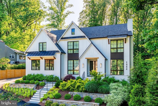 1544 Forest Villa Ln, Mclean, VA 22101 - view of front facade with a standing seam roof, roof with shingles, board and batten siding, a chimney, and metal roof